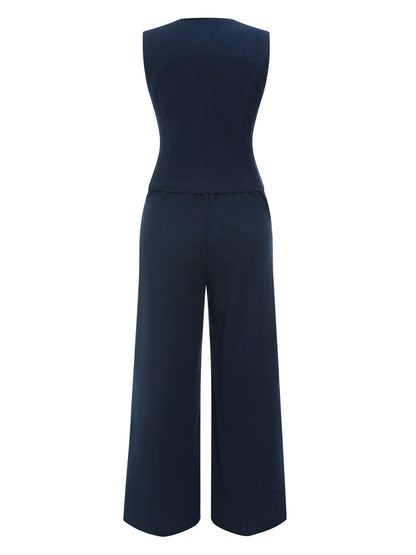 Dwuczęściowa bluzka z jednolitymi klapami i granatowa plisowana spódnica z lat 50. XX wieku